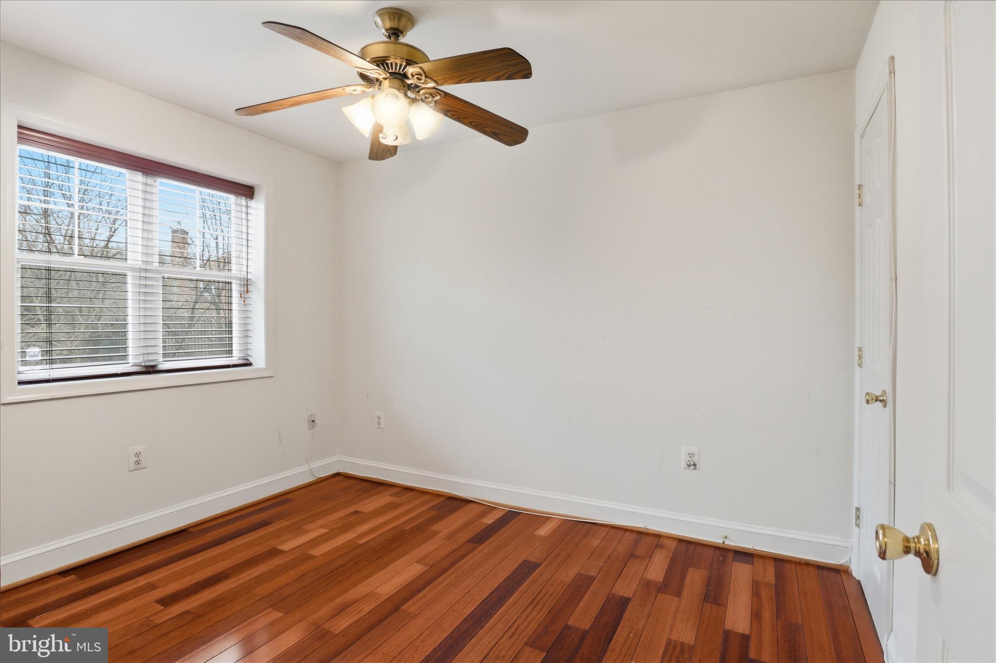 3866 9th Street Southeast, Unit 102 Washington, DC 20032 - Photo 11 of 21 a view of a room with wooden floor and a ceiling fan