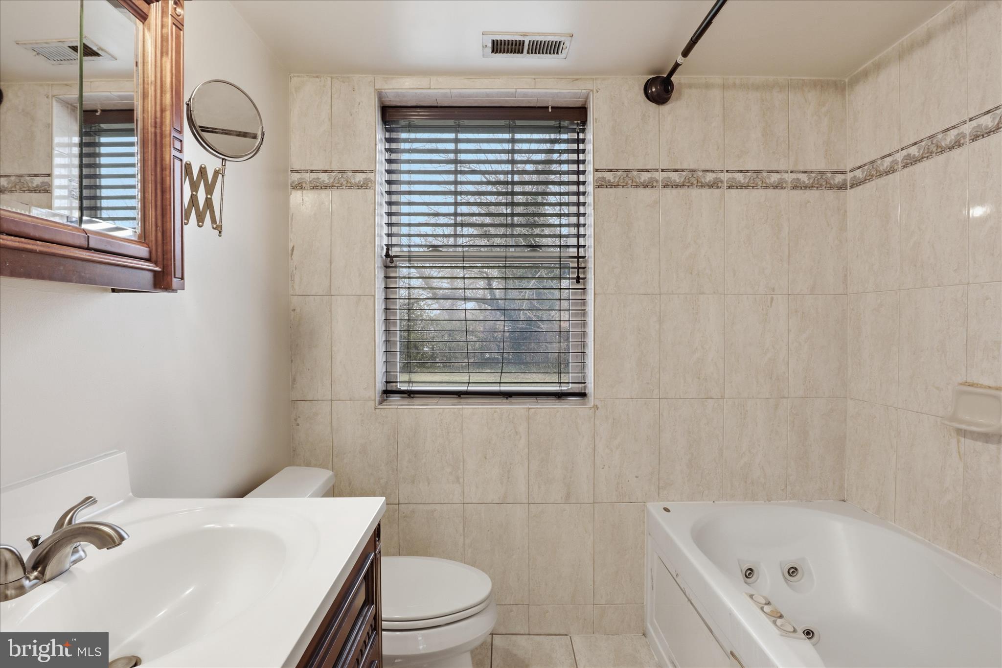 3866 9th Street Southeast, Unit 102 Washington, DC 20032 - Photo 12 of 21 a bathroom with a sink toilet and shower