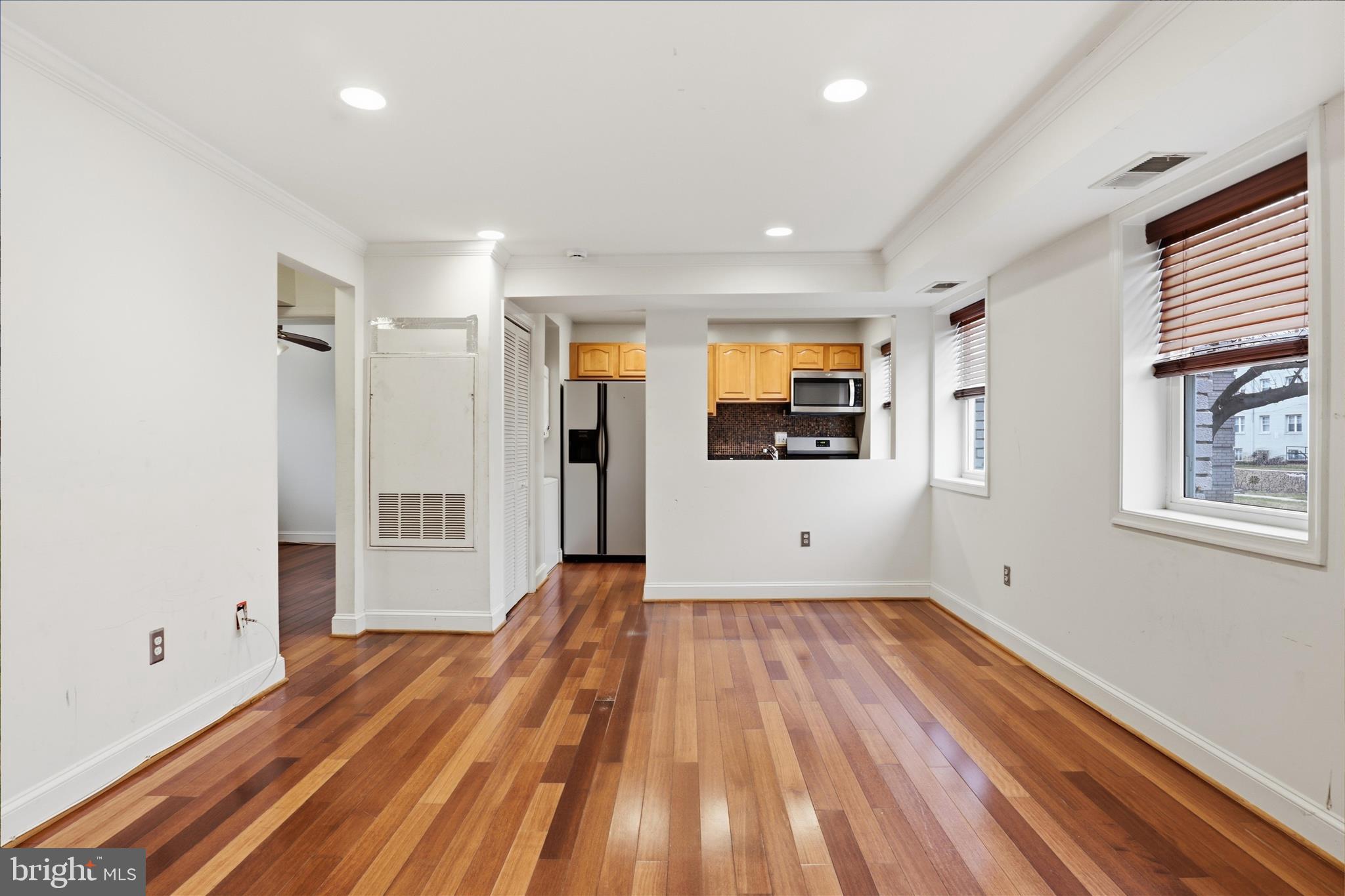 3866 9th Street Southeast, Unit 102 Washington, DC 20032 - Photo 3 of 21 a view of a room with wooden floor and an empty space