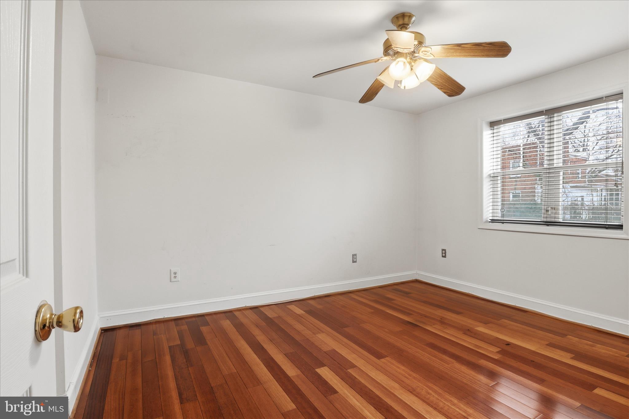 3866 9th Street Southeast, Unit 102 Washington, DC 20032 - Photo 9 of 21 wooden floor in an empty room with a window
