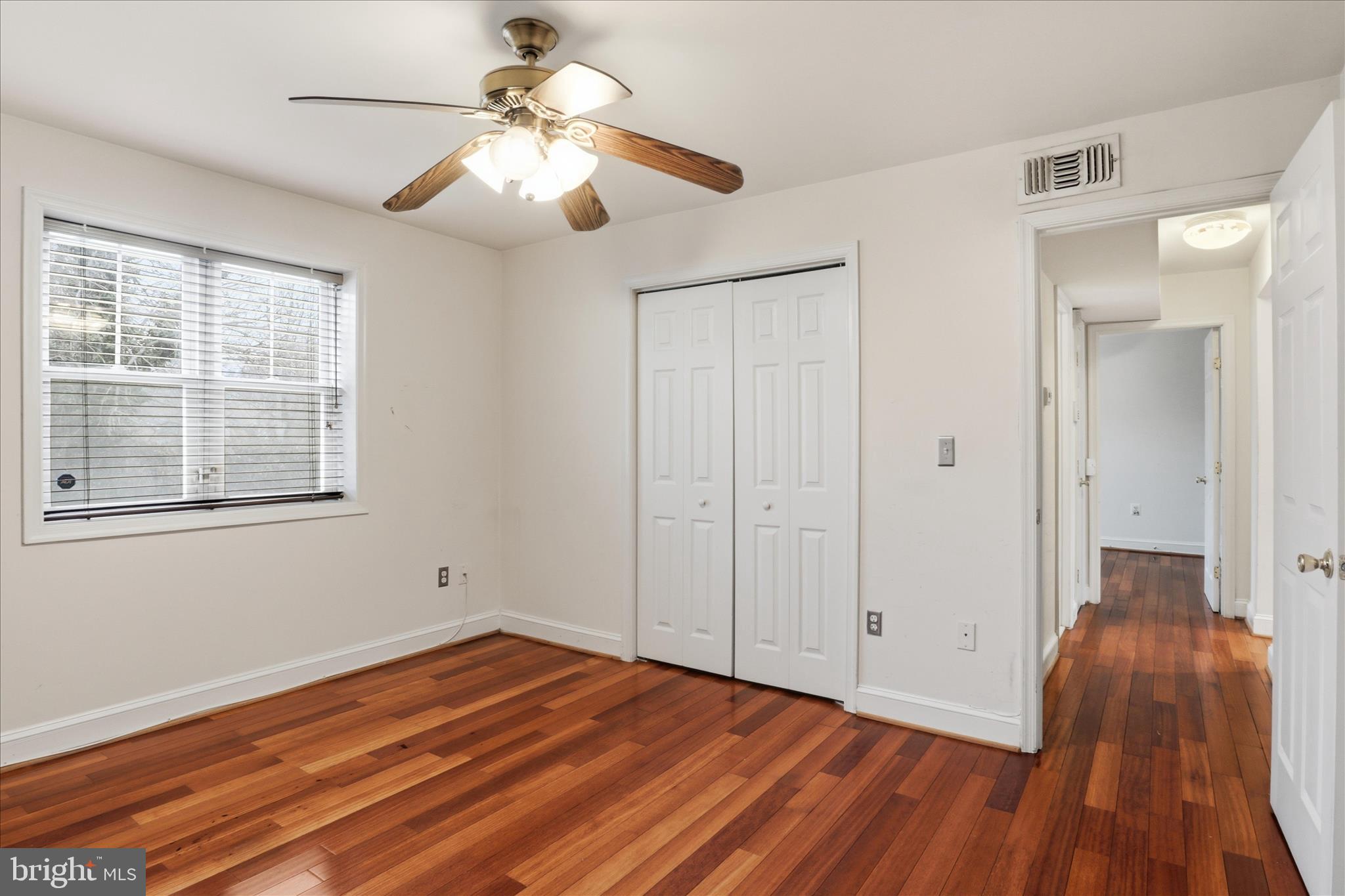 3866 9th Street Southeast, Unit 102 Washington, DC 20032 - Photo 10 of 21 a view of a livingroom with wooden floor and a ceiling fan