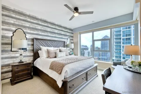 a bedroom with a bed and a large window
