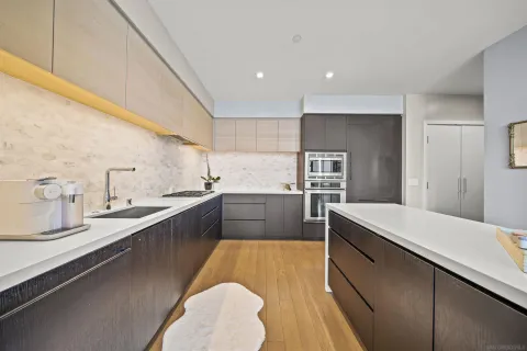 a large kitchen with kitchen island a sink stainless steel appliances and cabinets