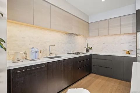 a kitchen with sink and cabinets