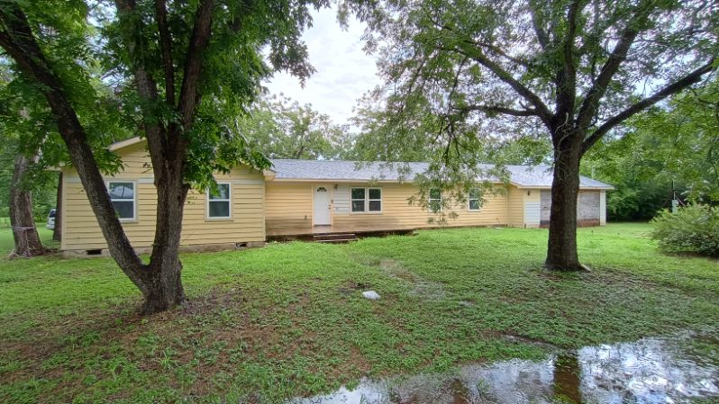112 Ila Street Elgin, TX 78621 - Photo 16 of 27 a view of a house with backyard and a tree