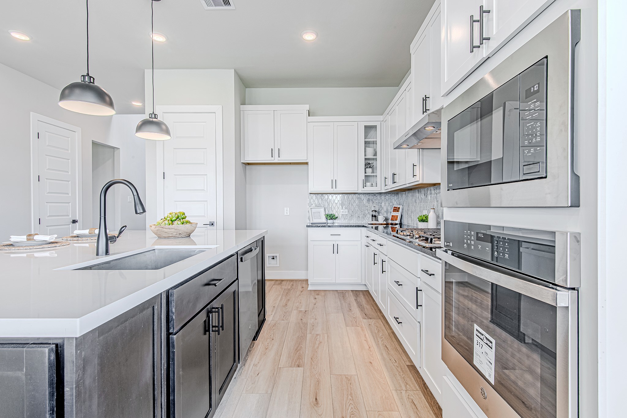 141 Peninsula Point Drive Montgomery, TX 77356 - Photo 11 of 47 This modern kitchen is equipped with sleek stainless appliances, a deep basin sink, and abundant cabinetry—perfectly blending functionality and style.