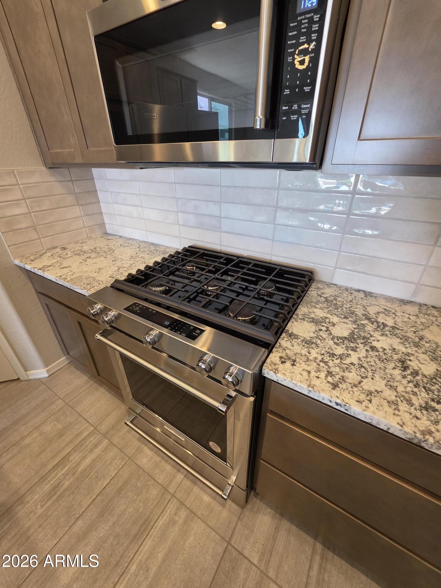 7128 West Coles Road Laveen, AZ 85339 - Photo 5 of 38 a stove top oven sitting inside of a kitchen