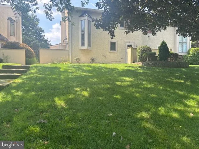 a view of house with backyard