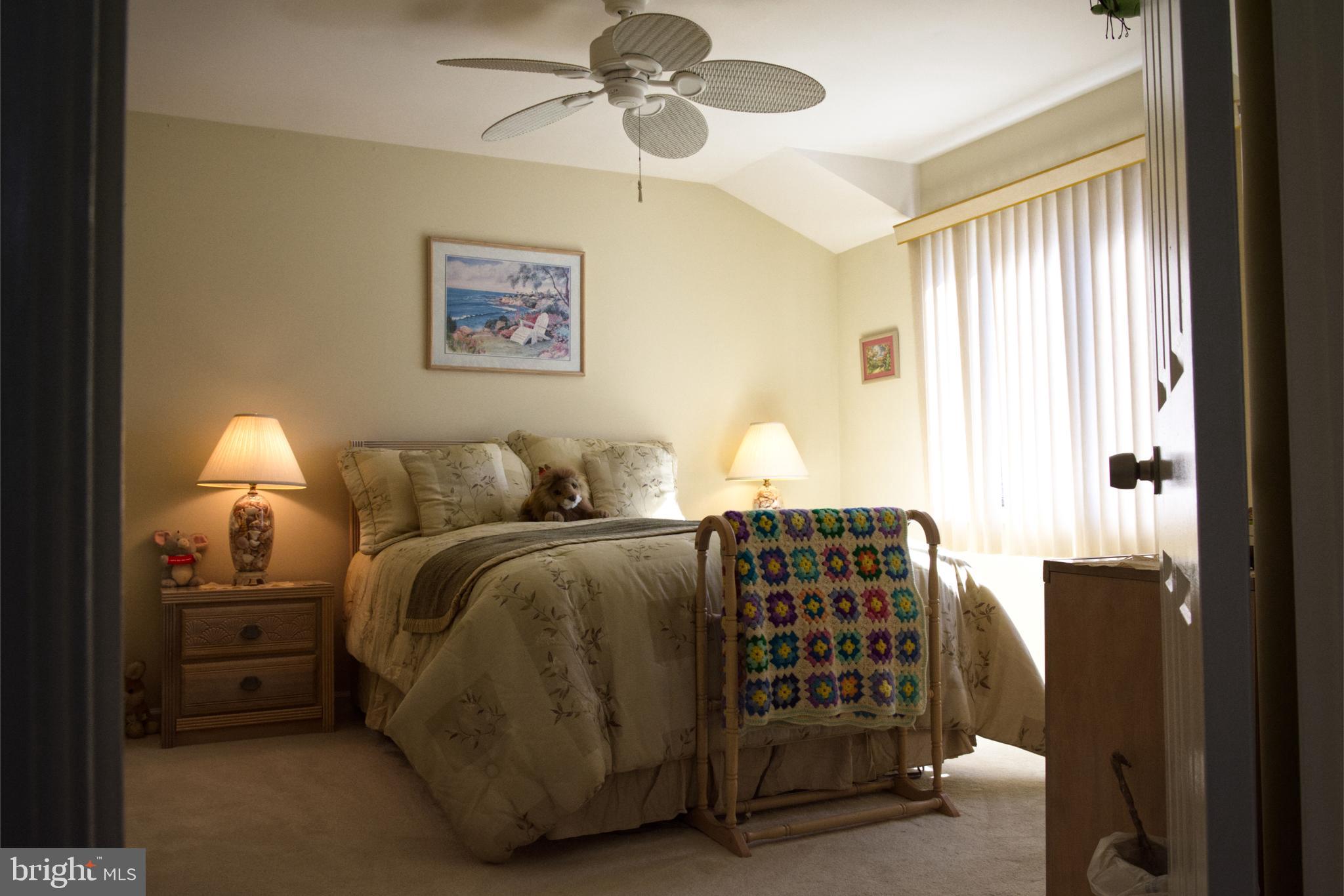 5 Greate Bay Drive Somers Point, NJ 08244 - Photo 12 of 62 a bedroom with a bed and a lamp with window