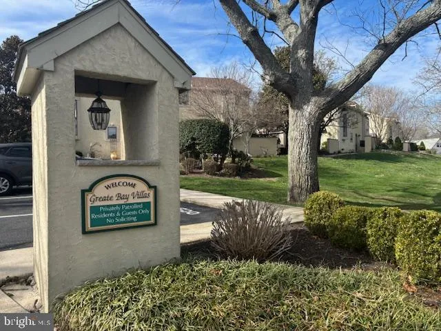 a view of a hallway to a livingroom with furniture