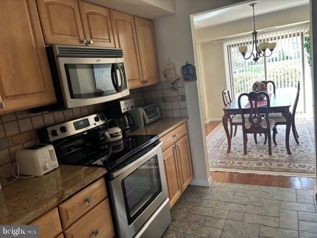 5 Greate Bay Drive Somers Point, NJ 08244 - Photo 29 of 62 a kitchen with granite countertop a stove a sink and a table