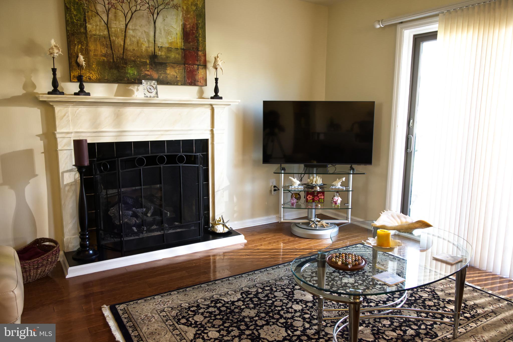 5 Greate Bay Drive Somers Point, NJ 08244 - Photo 7 of 62 a living room with fireplace furniture and a flat screen tv