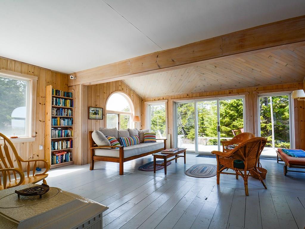 49 Atlantic Road Swans Island, ME 04685 - Photo 8 of 33 Living room with a wall of windows.