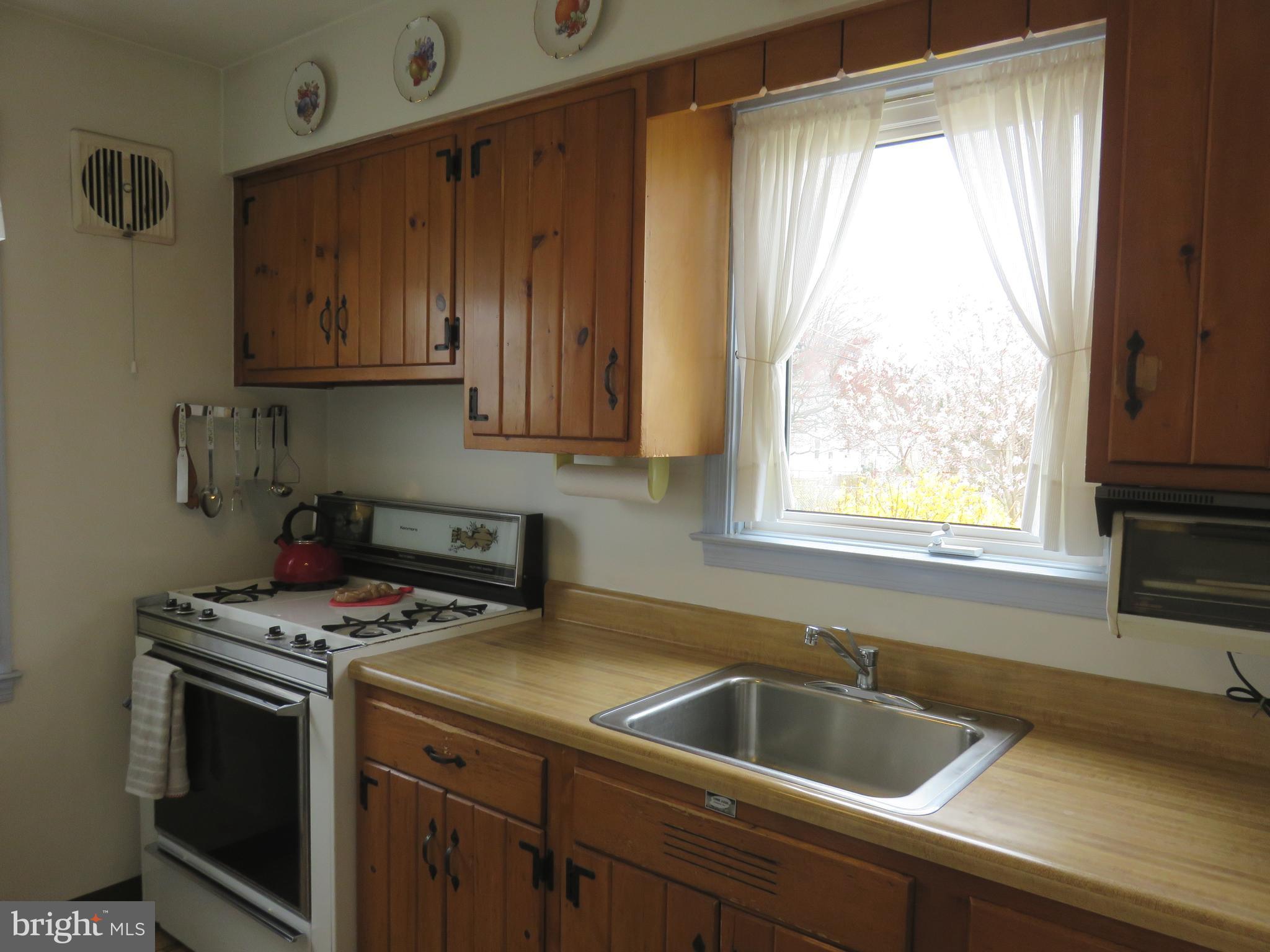 1804 Forrest Road Baltimore, MD 21234 - Photo 8 of 25 a kitchen with a sink a stove and cabinets