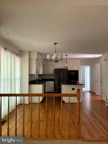 a view of a living room and kitchen with furniture