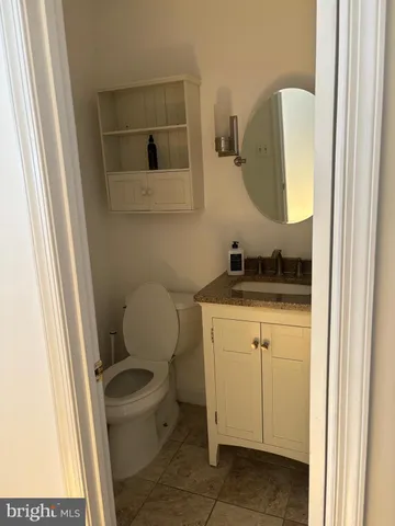 a bathroom with a toilet a sink and a mirror