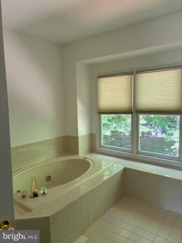 a bathroom with a bathtub and window