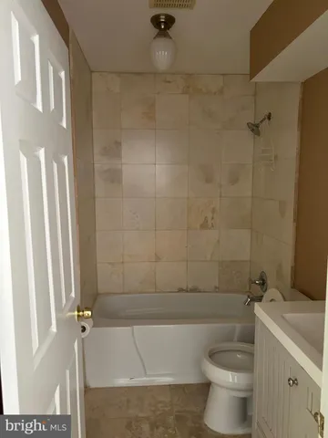 a bath room with a toilet and a bath tub