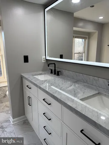 a bathroom with a sink a vanity and a mirror
