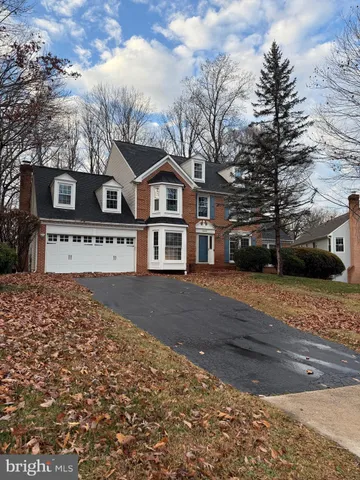 a front view of a house with a yard covered with snow in front of house