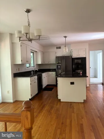 a kitchen with stainless steel appliances granite countertop a stove and a sink