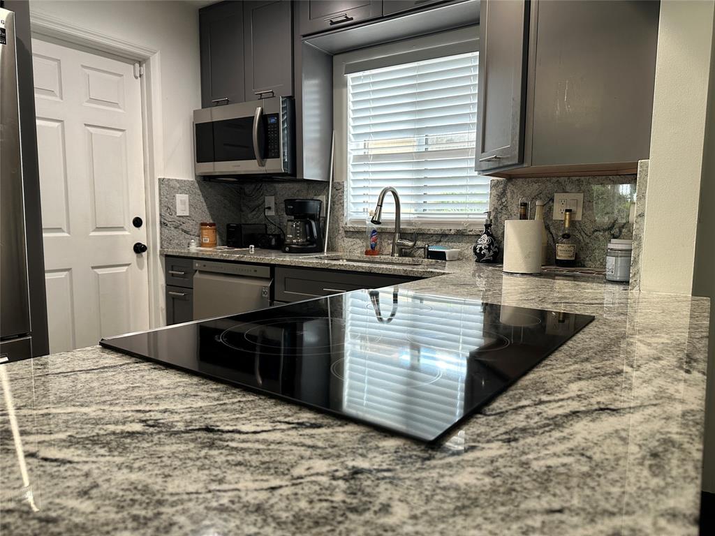 8121 Southwest 8th Street North Lauderdale, FL 33068 - Photo 3 of 16 a kitchen with stainless steel appliances granite countertop a stove a sink and a microwave