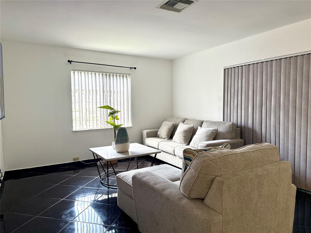 8121 Southwest 8th Street North Lauderdale, FL 33068 - Photo 8 of 16 a bedroom with bed and a window