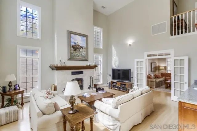 a dining hall with stainless steel appliances kitchen island granite countertop a table and chairs
