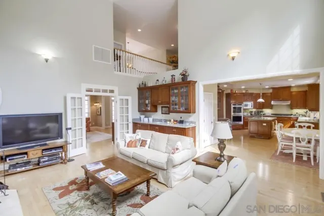 a kitchen with granite countertop a stove a sink and a wooden cabinets