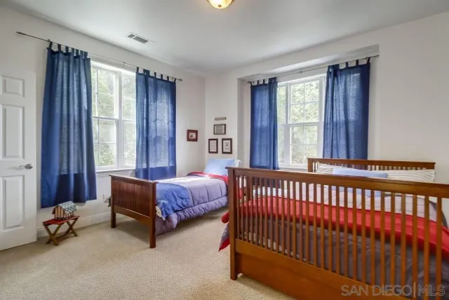a bedroom with furniture and a potted plant
