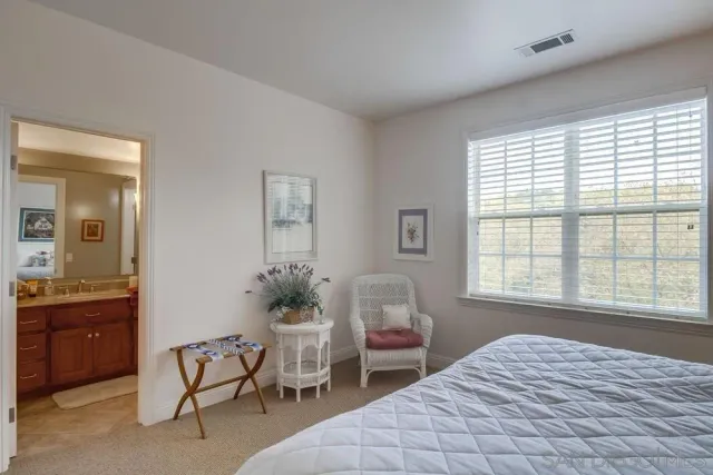 a living room with hardwood floor and a large window
