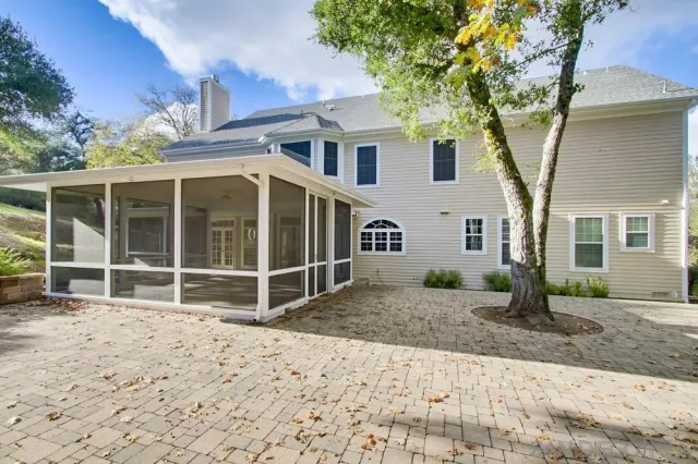 a front view of residential houses with yard and swimming pool