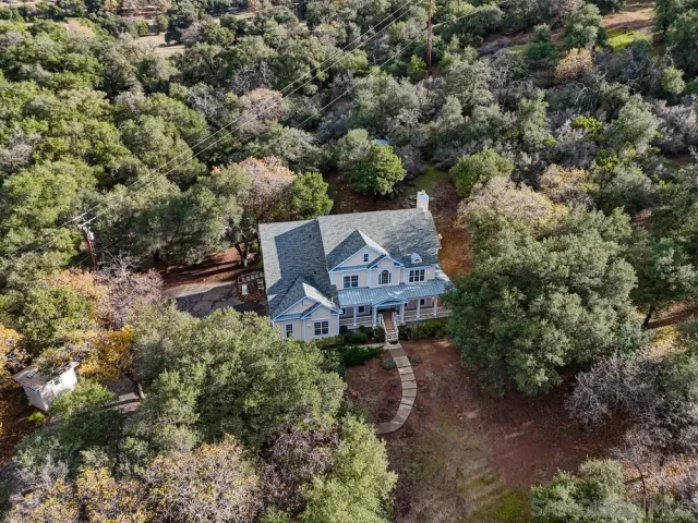 an aerial view of a house with a yard