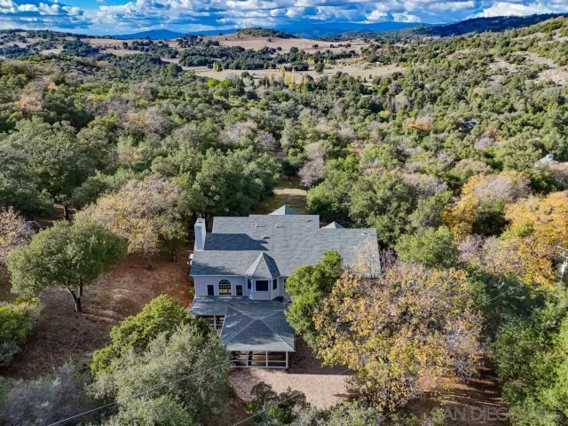 a view of house with backyard