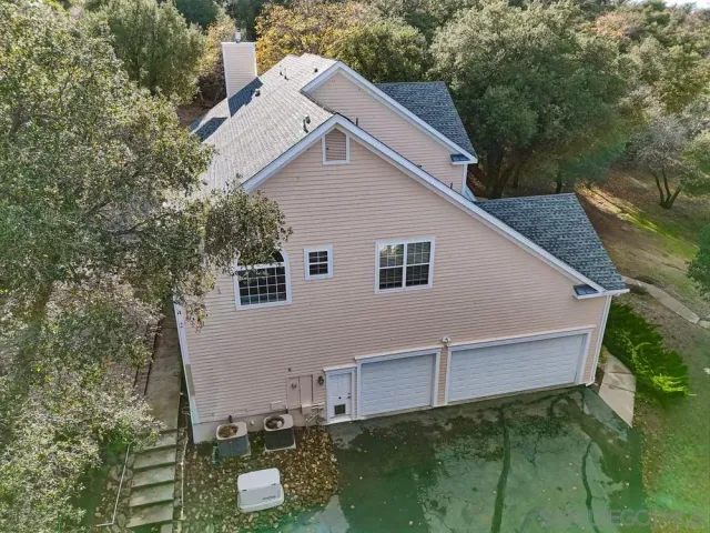 an aerial view of a house with a yard and garden