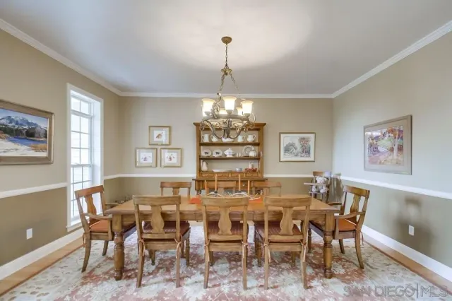a living room with furniture a large window and a fireplace