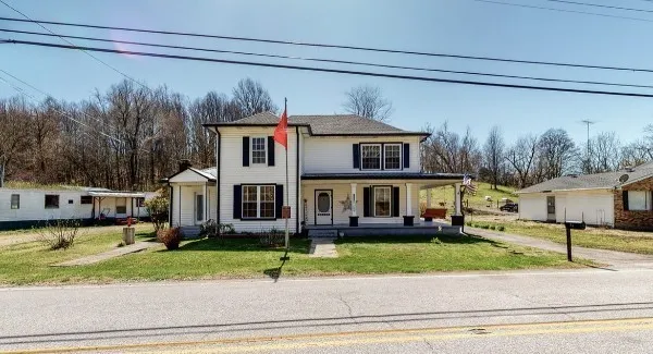 a front view of a house with a garden and plants