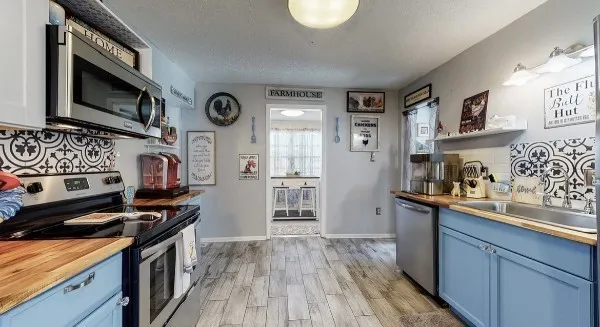 a view of hall way with furniture and chandelier
