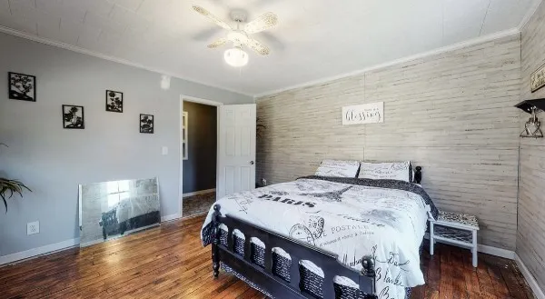 a bedroom with a bed and a chandelier