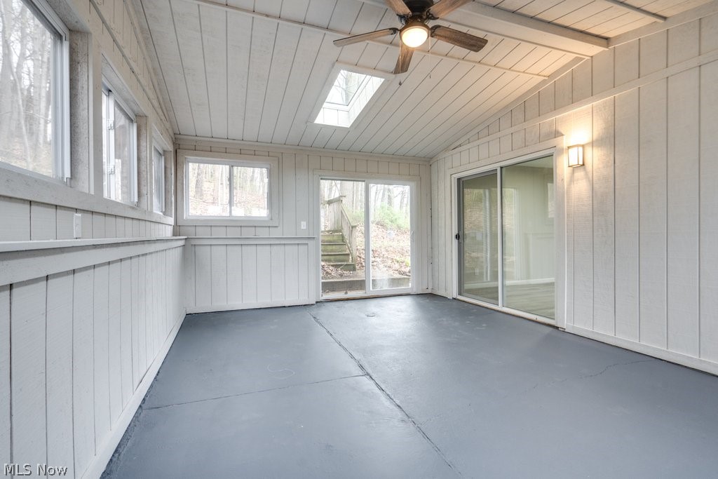 4596 Hattrick Road Rootstown, OH 44272 - Photo 22 of 45 Unfurnished sunroom featuring wood ceiling, ceiling fan, and lofted ceiling with skylight