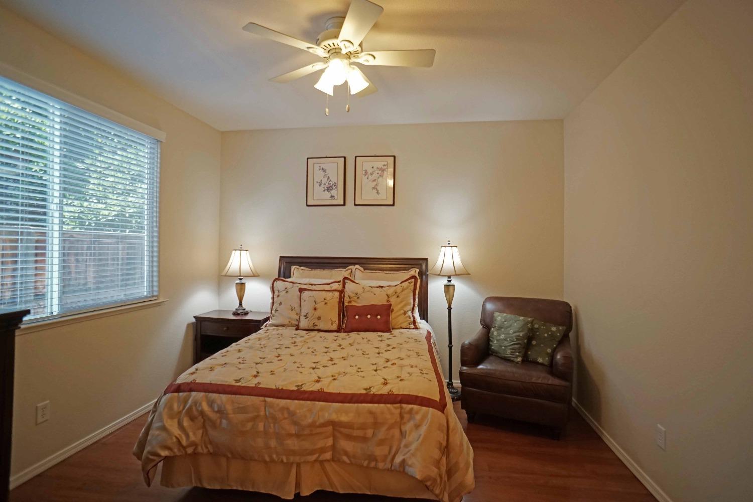 618 West Lisbon Lane Clovis, CA 93619 - Photo 16 of 26 a bedroom with a bed and a couch