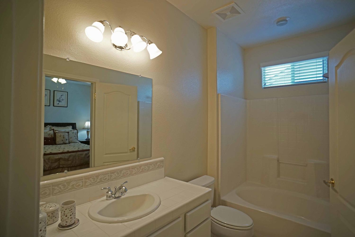 618 West Lisbon Lane Clovis, CA 93619 - Photo 19 of 26 a bathroom with a sink a toilet and shower