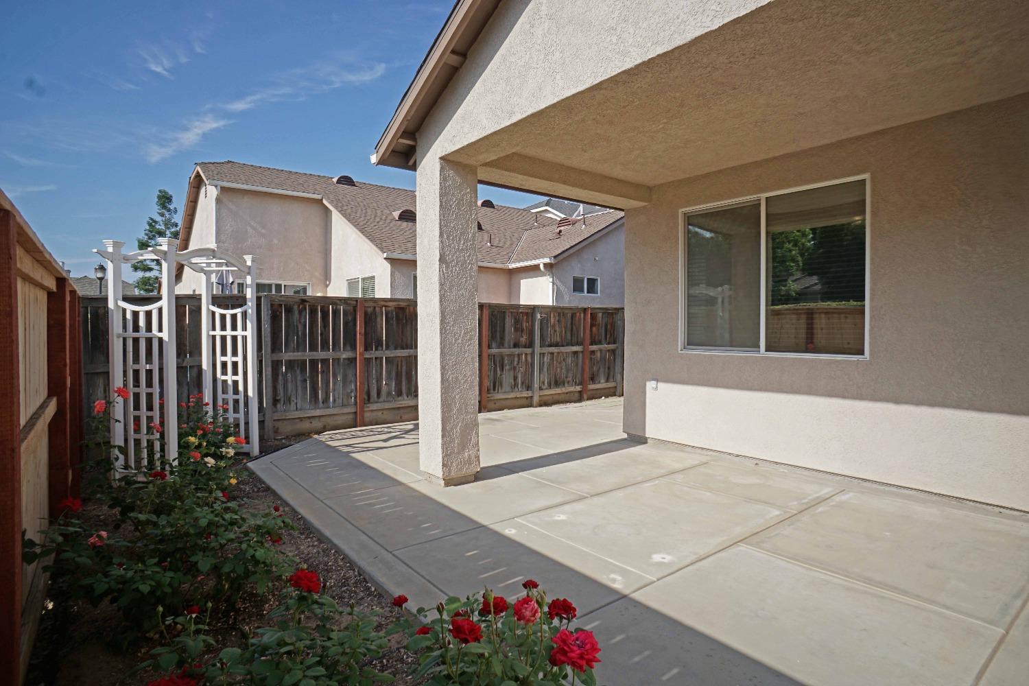 618 West Lisbon Lane Clovis, CA 93619 - Photo 22 of 26 a view of a house with a wooden fence