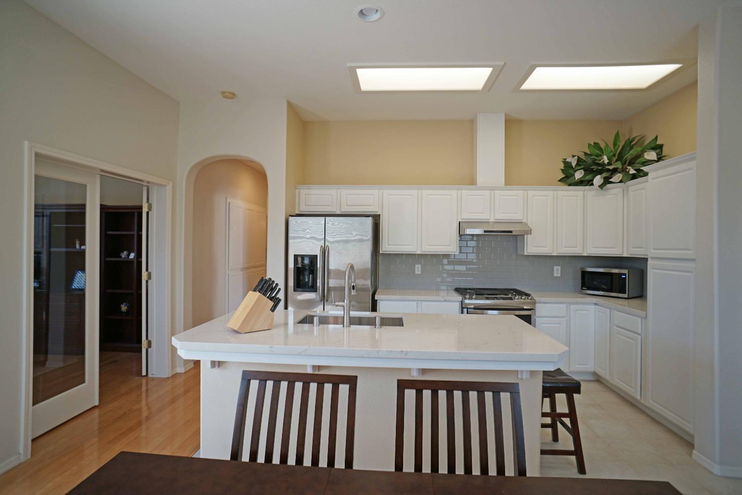 618 West Lisbon Lane Clovis, CA 93619 - Photo 6 of 26 a dining room with table chairs and chandelier