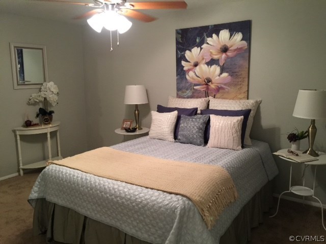 10506 White Rabbit Road Richmond, VA 23235 - Photo 14 of 27 a bedroom with a bed and a lamp on table