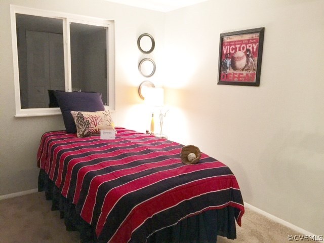 10506 White Rabbit Road Richmond, VA 23235 - Photo 17 of 27 a bedroom with a bed and a painting on the wall