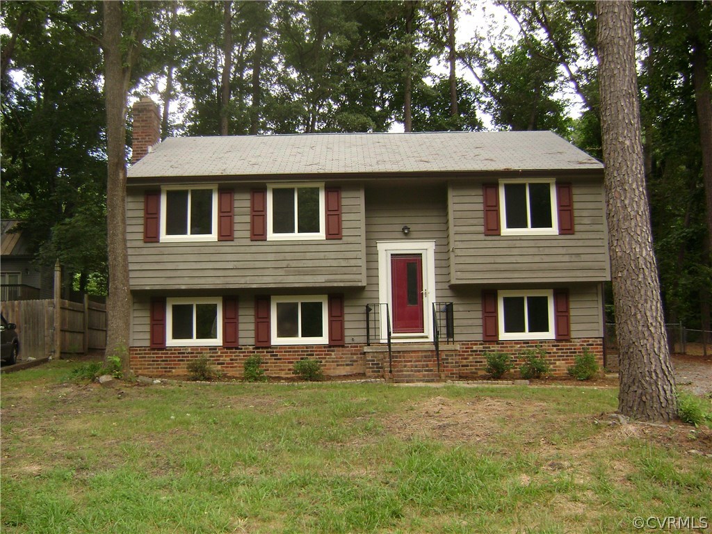 10506 White Rabbit Road Richmond, VA 23235 - Photo 27 of 27 a front view of a house with a garden