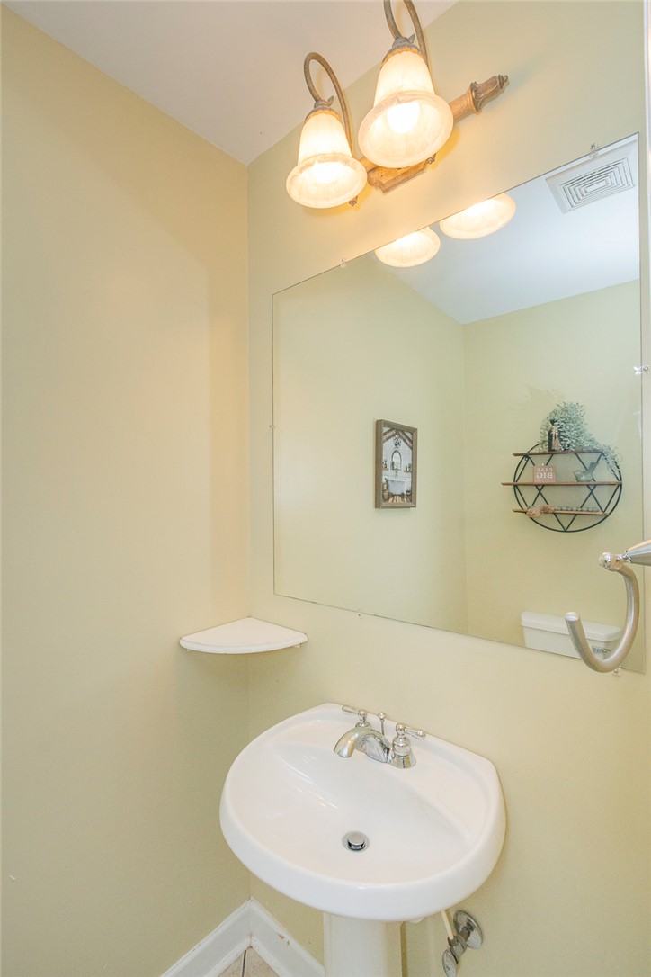 861 North Old Pendleton Road Liberty, SC 29657 - Photo 8 of 45 A compact pedestal sink and large mirror optimize space within this bright bathroom.