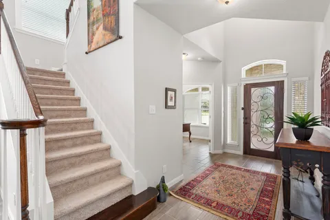 a view of an entryway with wooden floor and a rug
