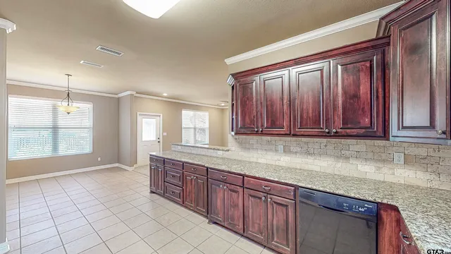 a view of a kitchen with granite countertop cabinets